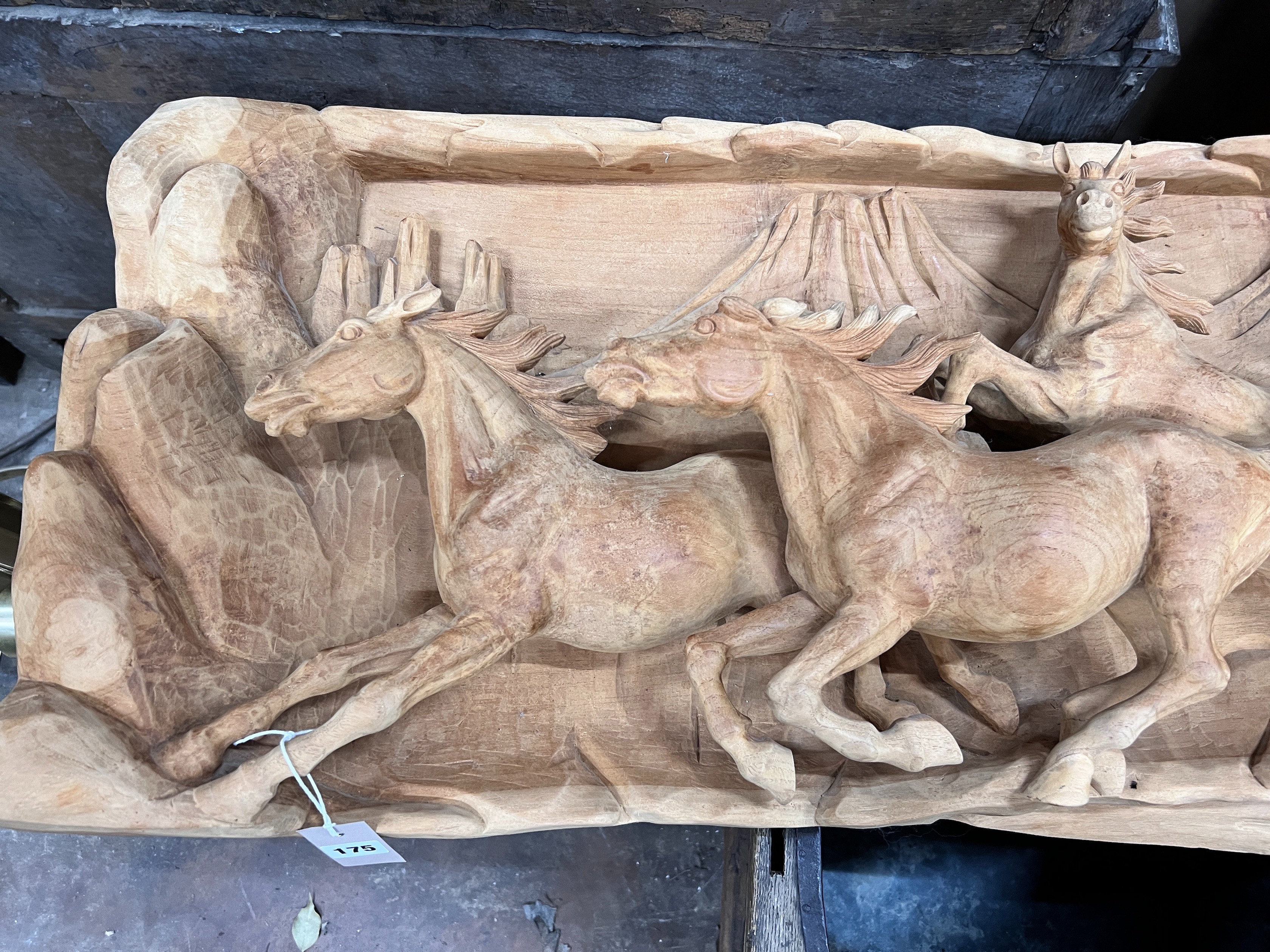 An unusual, probably American, carved wood panorama of eight galloping horses, width 200cm, height 46cm *Please note the sale commences at 9am.